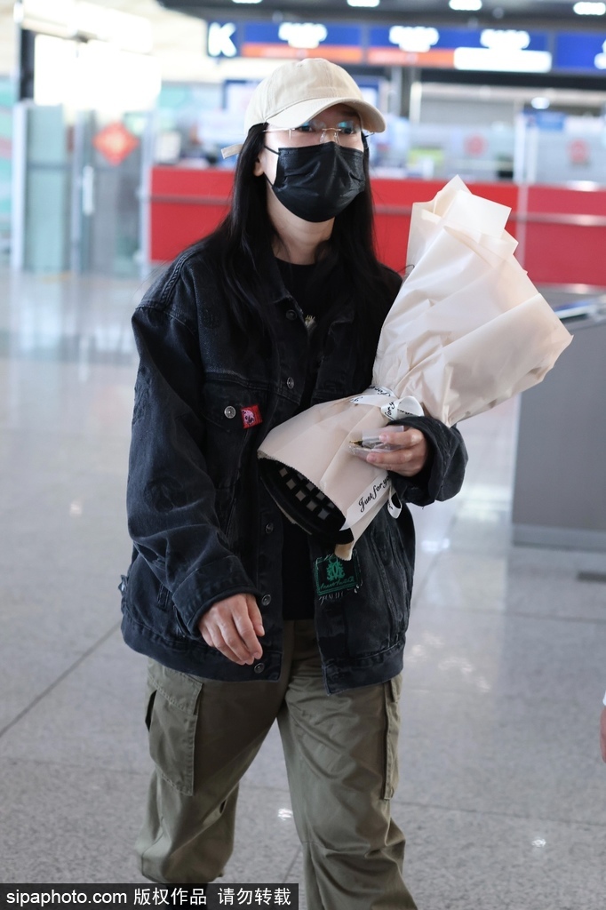 玲花戴棒球帽一身休闲装现身机场 手捧花束心情好